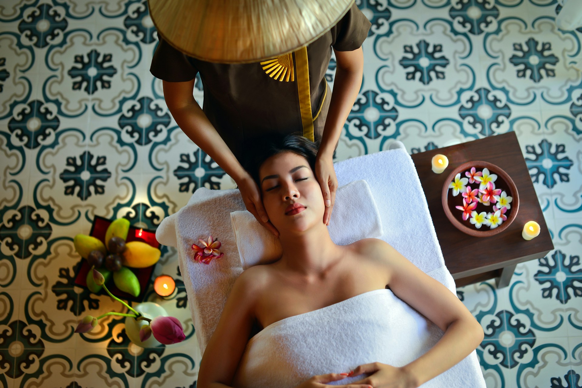 Therapist giving a relaxing head massage to a client at a spa
