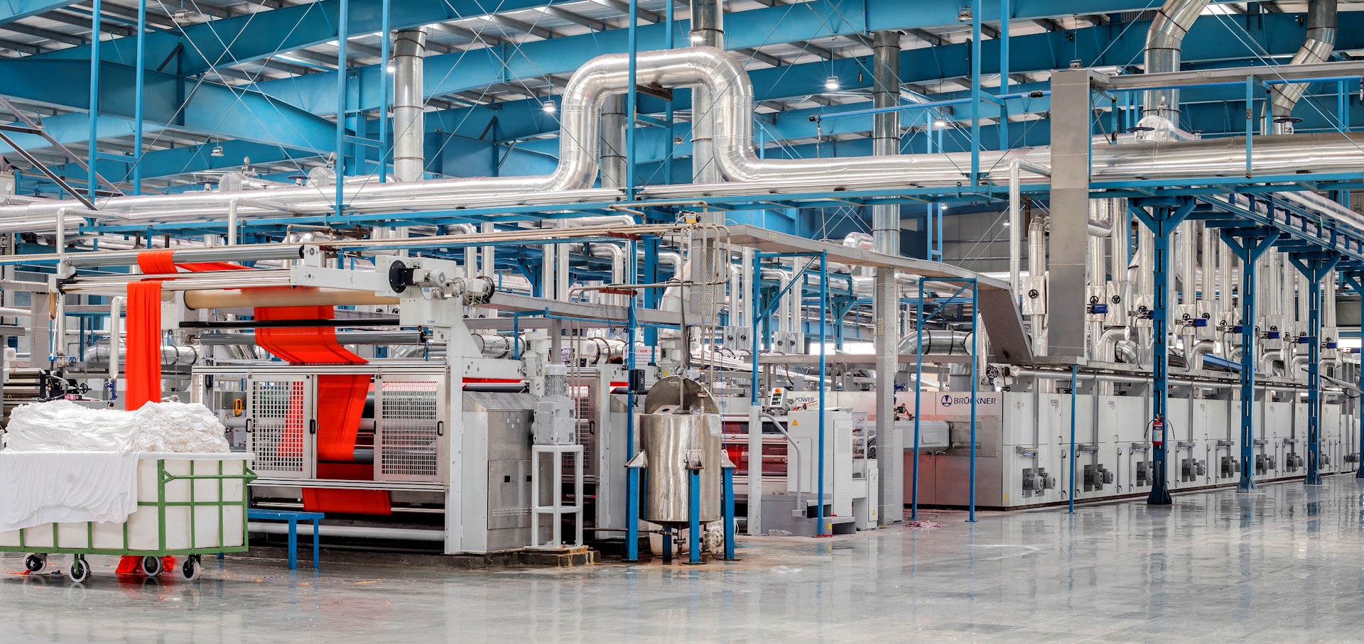 Modern textile factory floor with long automated production machinery